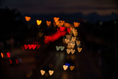 Heart shape bokeh from car light on the traffic road