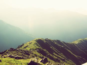 Scenic view of mountains against foggy sky