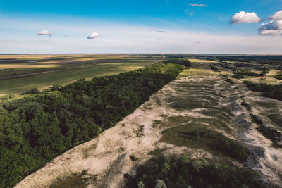 Scenic view of land and sea against sky