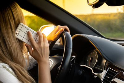 Midsection of woman using mobile phone