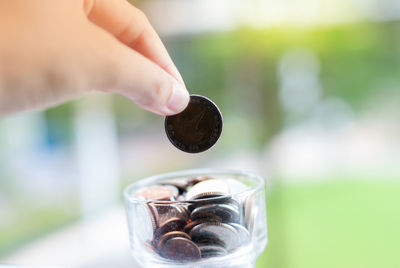 Close-up of hand holding candle against blurred background