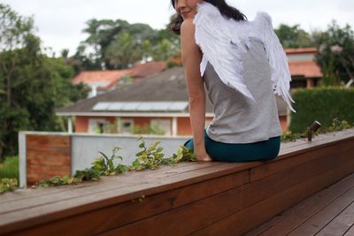 Woman standing against plants