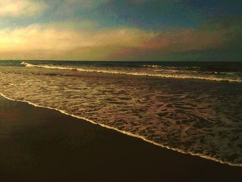 Scenic view of sea against cloudy sky