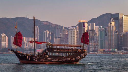 View of boats in sea against buildings in city