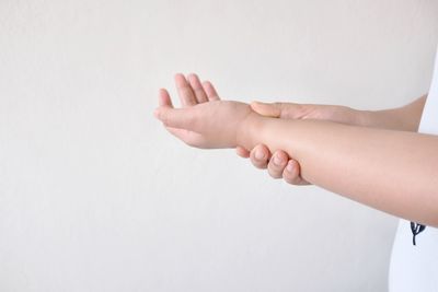 Close-up of hands over white background