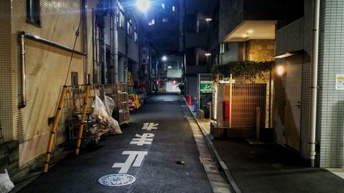 Street amidst illuminated city at night