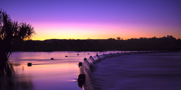 Scenic view of lake at sunset