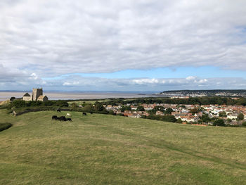 Scenic view of landscape and buildings against sky