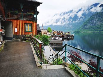 Bridge over river amidst buildings against sky