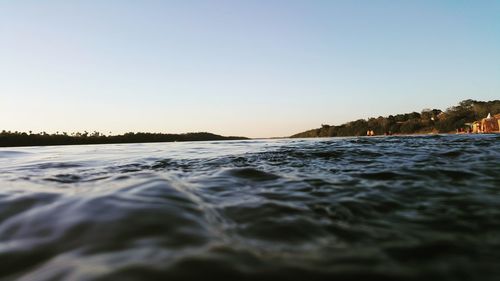 Scenic view of sea against clear sky during sunset