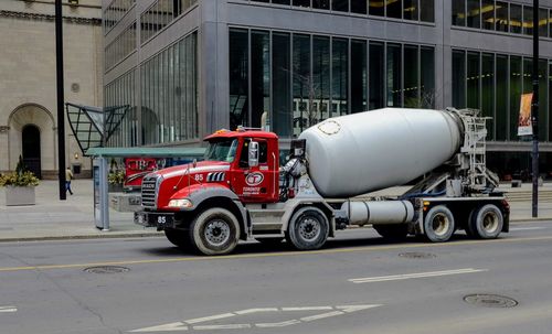 Side view of a vehicle on street against building