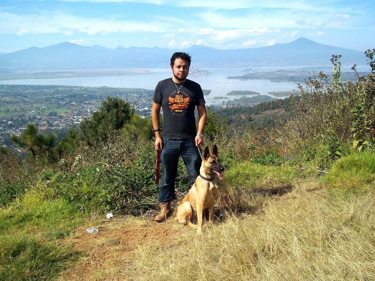 mountain, young adult, person, casual clothing, lifestyles, portrait, leisure activity, looking at camera, young men, sky, full length, smiling, mountain range, sunglasses, standing, tranquility, front view