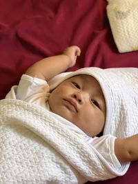 Portrait of cute baby boy sleeping on bed