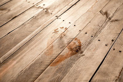 High angle view of footprint on wooden plank