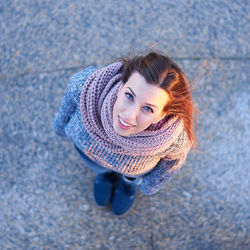 Portrait of smiling woman standing on footpath
