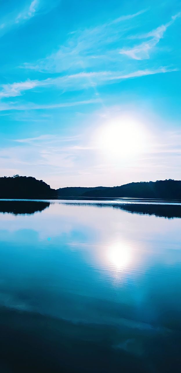 reflection, water, sky, scenics - nature, tranquility, beauty in nature, tranquil scene, horizon, lake, nature, cloud, blue, no people, environment, landscape, ocean, dusk, idyllic, sunlight, outdoors, land, non-urban scene, body of water, day, sun, travel destinations, sunrise, standing water