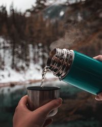 Close-up of hand holding glass bottle