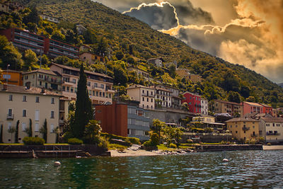 River by townscape against sky