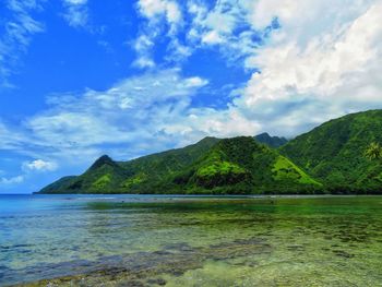 Scenic view of sea and mountains against sky