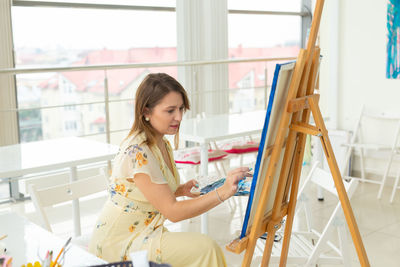 Woman sitting in front of building