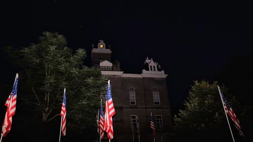 Low angle view of illuminated building against sky at night