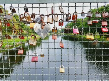 Close-up of padlocks hanging on water