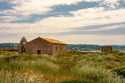 House on field against sky