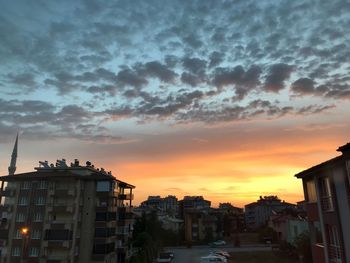 Buildings in city during sunset