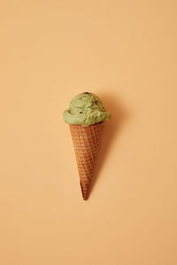 Close-up of ice cream cone against white background