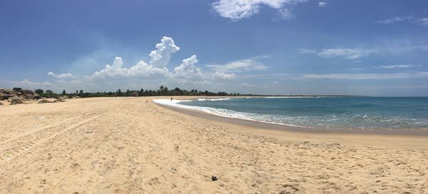 Scenic view of beach against blue sky