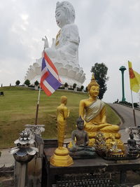 Statue against temple against sky