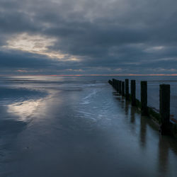 Scenic view of sea against sky at dawn