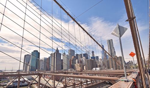 High angle view of bridge cables against cloudy sky