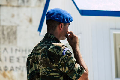 Young man wearing hat looking at camera