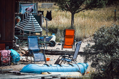 View of abandoned chairs on field