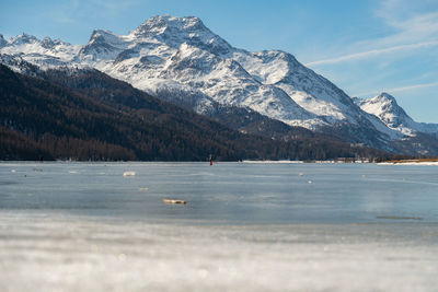 Switzerland, february 21, 2023 panorama with frozen lake of silvaplana and the mount corvatsch