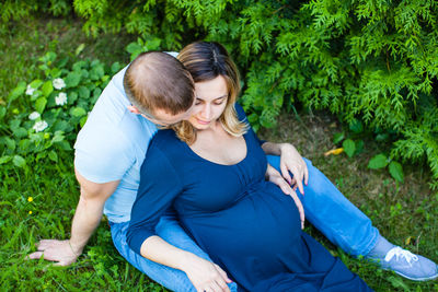 Young couple sitting outdoors