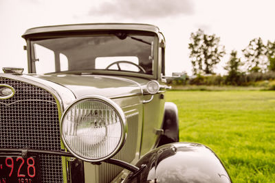 Close-up of vintage car on field