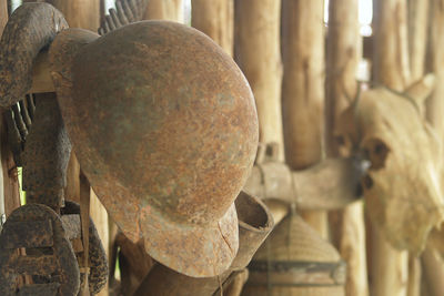 Close-up of casque rusty old sculpture on wooden fence 