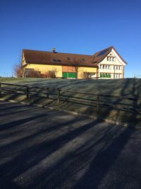 House by building against clear blue sky