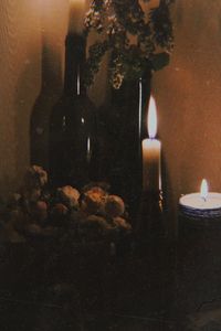 Close-up of lit candles on wall