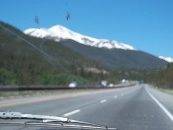 Scenic view of mountains against blue sky