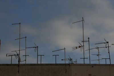 Low angle view of communications tower against sky