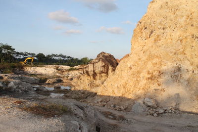 Rock formations on landscape against sky