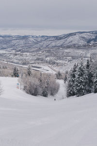 Scenic view of mountain road against sky during winter