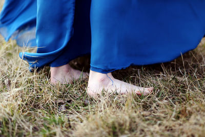 Low section of woman on field