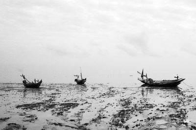 Low angle view of fishing boat on sea against sky