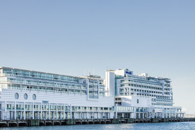 Modern buildings against clear blue sky