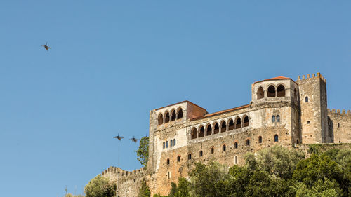 Low angle view of historical building against blue sky