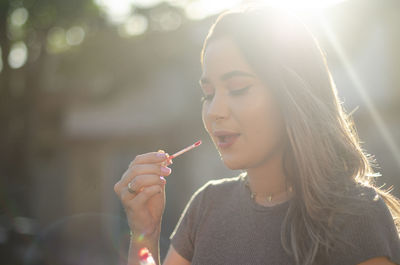 Portrait of beautiful woman drinking water